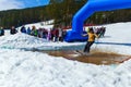 BELORETSK,RUSSIA, 13 APRIL 2019 - a man skier passes through a pool filled with water on the ski track in the Ural mountains Royalty Free Stock Photo