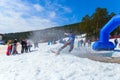 BELORETSK,RUSSIA, 13 APRIL 2019 - a man snowboarder passes through a pool filled with water on the ski track in the Ural mountains Royalty Free Stock Photo