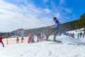 BELORETSK,RUSSIA, 13 APRIL 2019 - young man snowboarder makes a jump on the ski slope in the Ural mountains Royalty Free Stock Photo