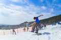 BELORETSK,RUSSIA, 13 APRIL 2019 - young man snowboarder makes a jump on the ski slope in the Ural mountains Royalty Free Stock Photo
