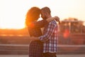 Beloved couple embracing and touching their foreheads at sunset