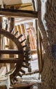 From below shot of aged water mill turning inside weathered mill building