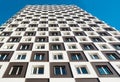 From below shot of modern and new apartment building. Photo of a tall block of flats against a blue sky. Royalty Free Stock Photo