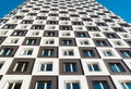 From below shot of modern and new apartment building. Photo of a tall block of flats against a blue sky. Royalty Free Stock Photo