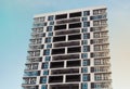 From below shot of modern and new apartment building. Photo of a tall block of flats against a blue sky. Royalty Free Stock Photo