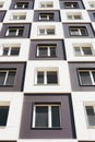 From below shot of modern and new apartment building. Photo of a tall block of flats against a blue sky. Royalty Free Stock Photo