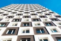 Modern and new apartment building. Photo of a tall block of flats against a blue sky. Royalty Free Stock Photo