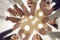 Team of people joining gears as metaphor for effective teamwork and finding working solution Royalty Free Stock Photo