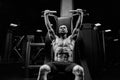 Shirtless muscular bodybuilder training back on simulator. Royalty Free Stock Photo