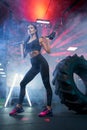 Fit woman posing with sledgehammer in gym. Royalty Free Stock Photo