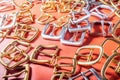 Belt buckles on red full grain leather background