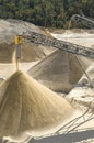 Belt conveyors and a piles of rubble and stone meal in Gravel Quarry Royalty Free Stock Photo