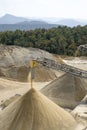 Belt conveyors and a piles of rubble and stone meal in Gravel Quarry Royalty Free Stock Photo