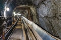 Belt conveyot in illuminated underground tunnel Royalty Free Stock Photo