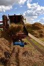 A belt driven threshing machine is in full operation Royalty Free Stock Photo