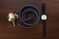 A belt, rings, watch, boutonniere