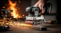 Belt sander in action on metal surface creating sparks during workshop work Royalty Free Stock Photo