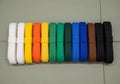Belts are arranged in a row, displaying a gradient from white to Royalty Free Stock Photo