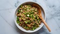 Beluga lentil herb salad in bowl on wooden spoon against marbled backgroun. Concept Food