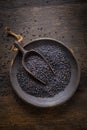 Beluga lentils on wooden background. Black lentils in bowl