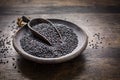 Beluga lentils on wooden background. Black lentils in bowl