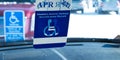 Handicapped parking sign and handicapped placards in car window Royalty Free Stock Photo