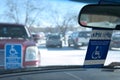 BEMIDJI, MN - 27 FEB 2019: Handicapped parking sign and handicapped placards in car windows Royalty Free Stock Photo