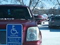 BEMIDJI, MN - 27 FEB 2019: Handicapped parking sign and red car with handicapped placard Royalty Free Stock Photo