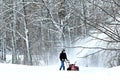 BEMIDJI, MN - 22 JAN 2019: Man uses snow blower to remove newly fallen snow from driveway Royalty Free Stock Photo