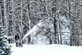 BEMIDJI, MN - 22 JAN 2019: Man uses snow blower to remove newly fallen snow from driveway Royalty Free Stock Photo