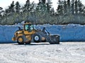 Front end loader takes short rest and tilts back on two wheels during job