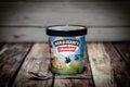 Ben & Jerry`s Strawberry Cheesecake Soft Ice Cream on the woodenen background. - Image