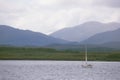 Ben More towers over the yacht passing down the Sound of Mull