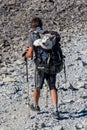 BEN NEVIS, SCOTLAND - SEPTEMBER 01 2021: A hiker carries a large dog in a backpack down from the summit of Ben Nevis, Scotland