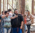 Member of the annual reconstruction of the life of the Vikings - `Viking Village` teaches visitor how to shoot arrows in the fores