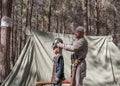 The participant of the reconstruction `Viking Village` Helps the visitor to wear armor in the camp in the forest near Ben Shemen i