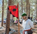 The reconstruction participant of the `Viking Village` stands with the flag in the camp in the forest near Ben Shemen in Israel