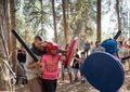 The reconstruction participant of the `Viking Village` teaches children swordfighting in the camp in the forest near Ben Shemen in