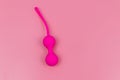 Ben Wa balls or Geisha balls on pink background. Pink double vaginal balls