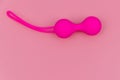 Ben Wa balls or Geisha balls on pink background. Pink double vaginal balls