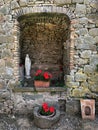 Ancient stone wall with red geranium flowers in pots Royalty Free Stock Photo