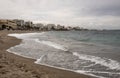 Benalmadena beach on a cloudy day in spain with buildings in the background