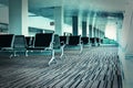 Bench in the airport hall. Photo with color filters and film gra Royalty Free Stock Photo