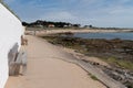 Bench in beach sand and rocks of island of Noirmoutier in Vendee France Royalty Free Stock Photo