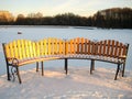 Bench in beams of the winter sun in the park of a Royalty Free Stock Photo