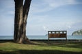 A bench with blurred blue sea and sky in background.Secluded place for near the sea shore.lonely concept.selective focus.