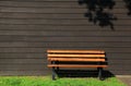 bench by brown siding wall Royalty Free Stock Photo