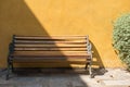 bench chair near yellow wall Royalty Free Stock Photo
