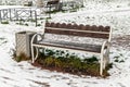 A bench covered with ice next to the urn Royalty Free Stock Photo