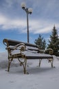 Bench covered with snow in a park in winter Royalty Free Stock Photo